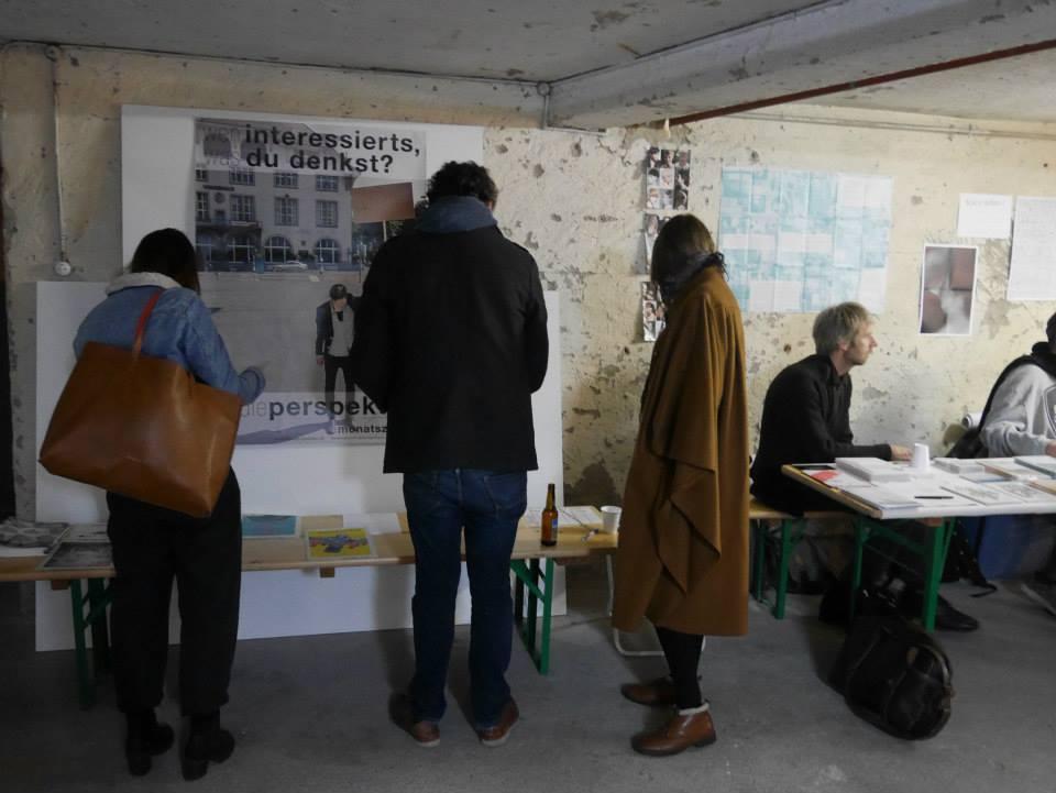 People in a room, looking at books