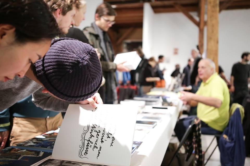 People looking closely at a book