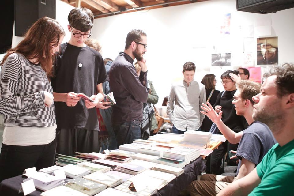 People looking at publications at book stands