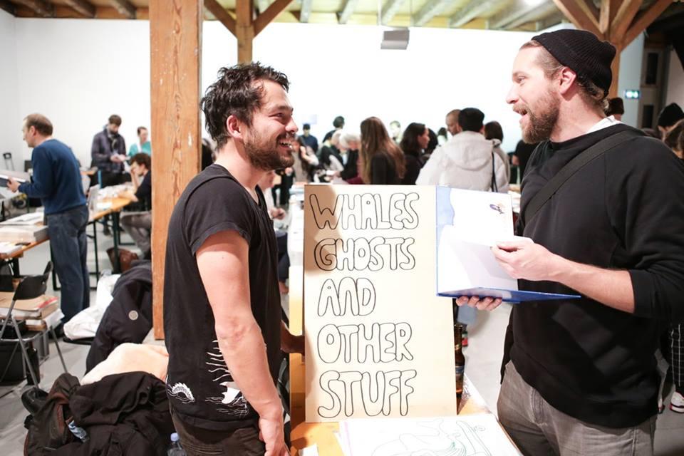 © Spyros Paloukis Two guys talking to each other over a publication