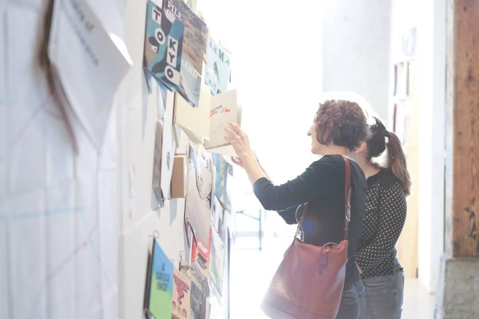 © Spyros Paloukis Two girls looking at publications which are hanging at a wall