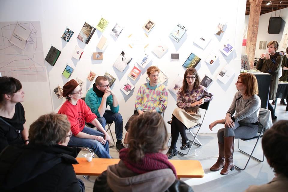 People sitting in a circle holding a talk