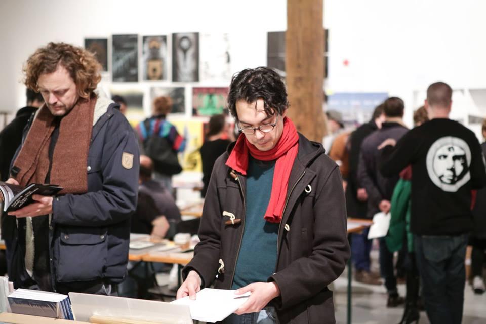 People standing in front of book stands