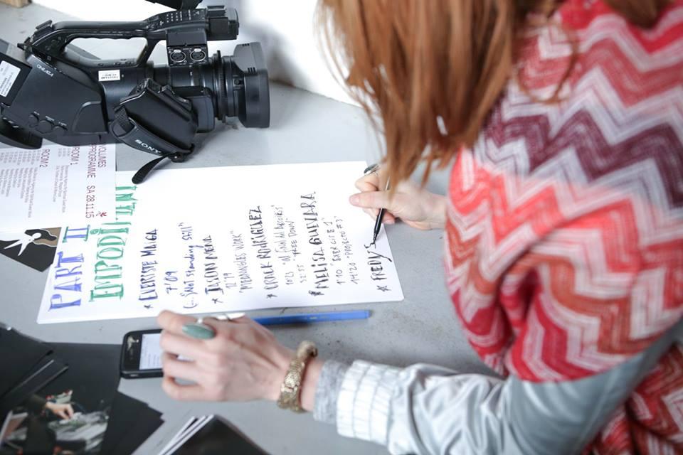 Girl writting the program of the screening on a piece of paper