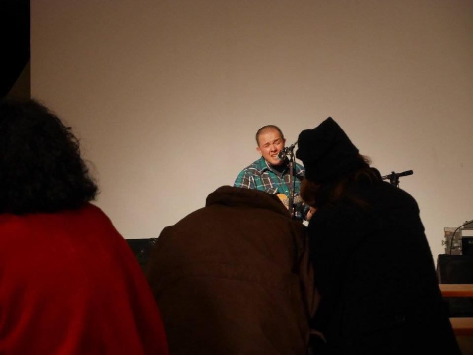 A guy playing the ukulele