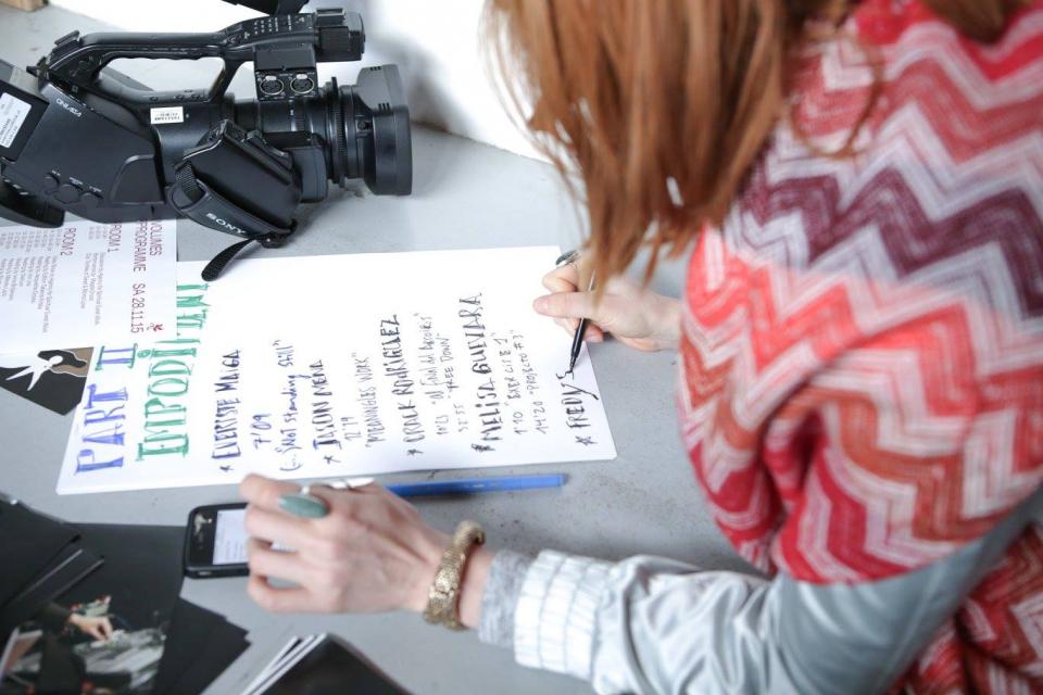 A girl writting the screening program on a piece of paper