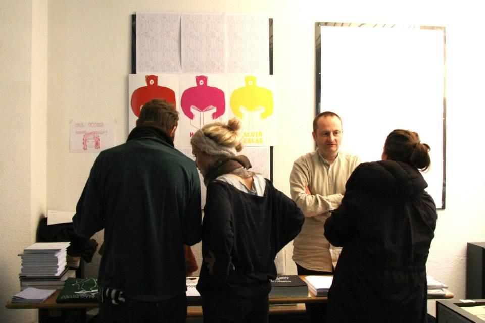 A publisher explaining his books to customers