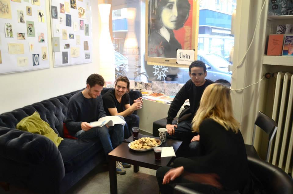 People sitting on a couch, talking to each other